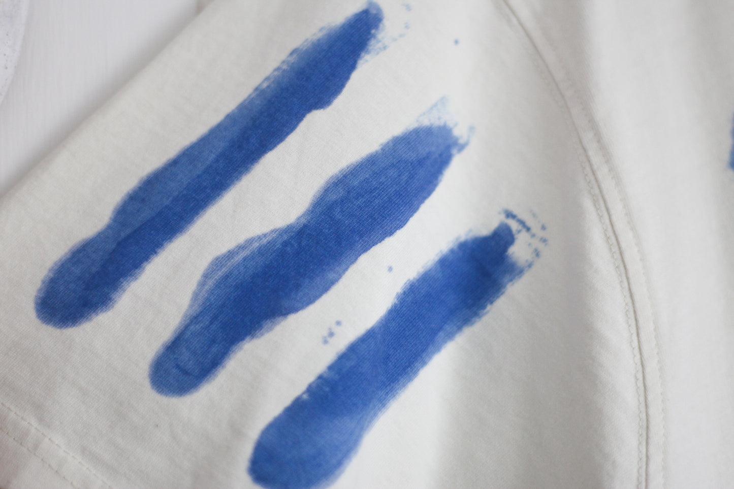 Hand painted three stripe design on a t-shirt sleeve.