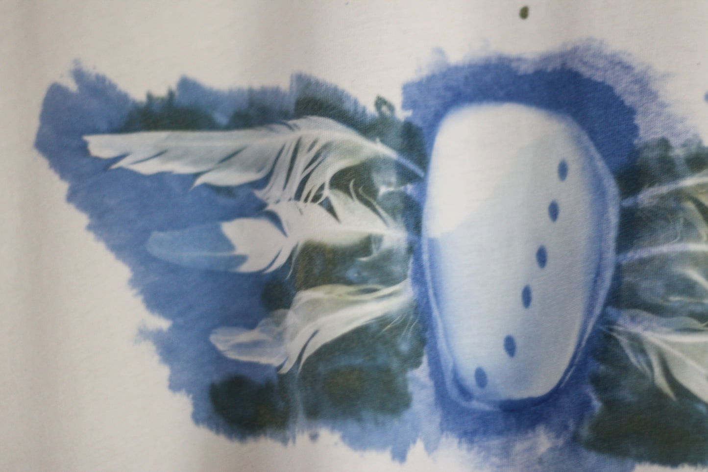 Hand-printed abalone shell and feather design graphic t-shirt.