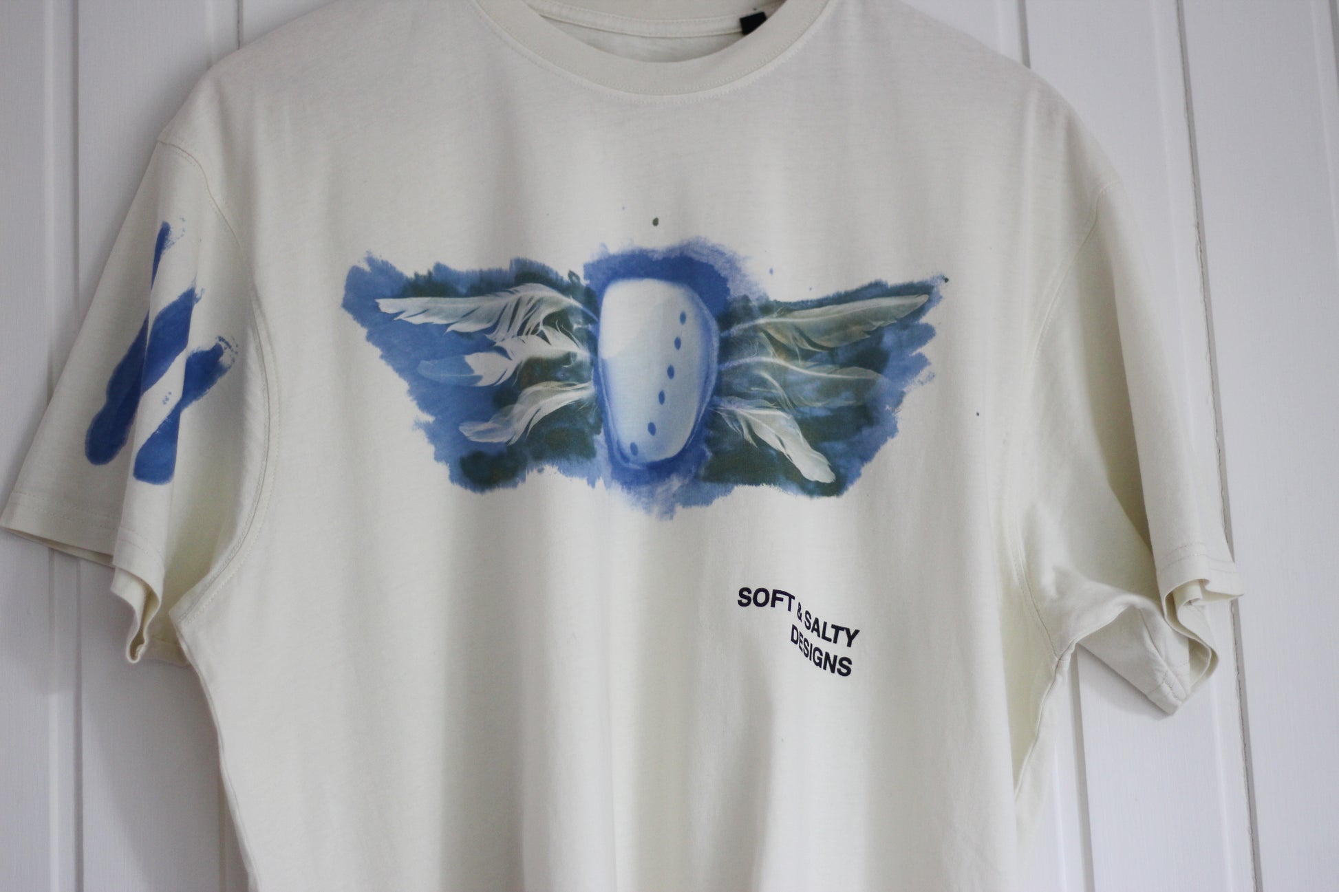 Hand-printed abalone shell and feather design graphic t-shirt.