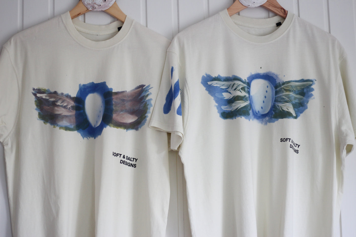 Two hand-printed abalone shell and feather design t-shirts.