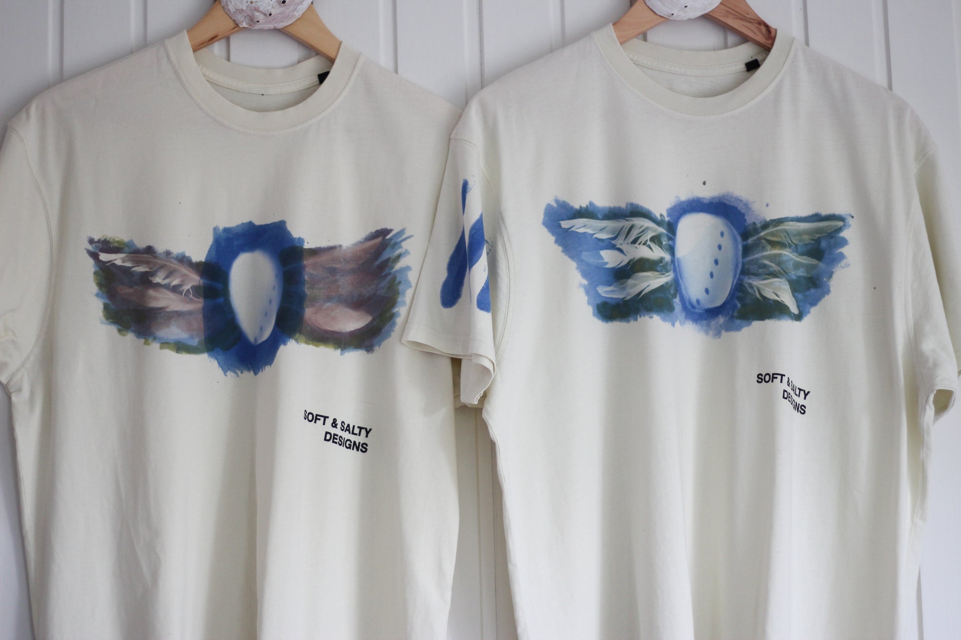 Two hand-printed abalone shell and feather design t-shirts.