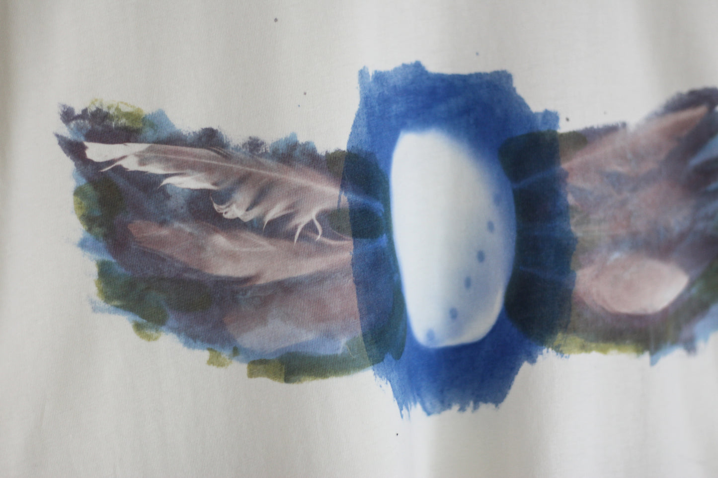 Hand-printed abalone shell and feather design graphic t-shirt.