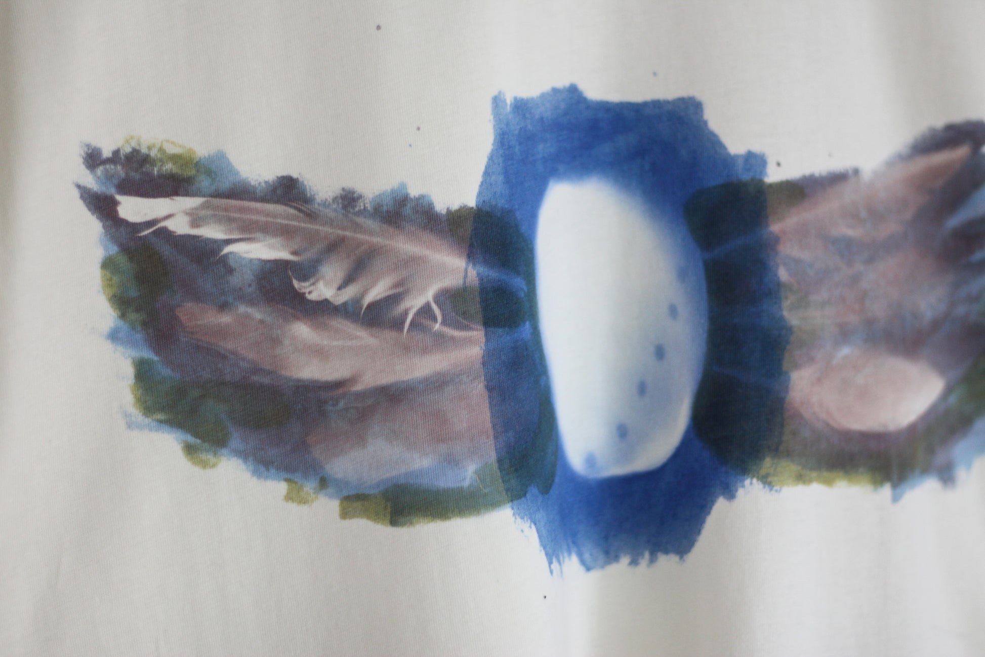 Hand-printed abalone shell and feather design graphic t-shirt.