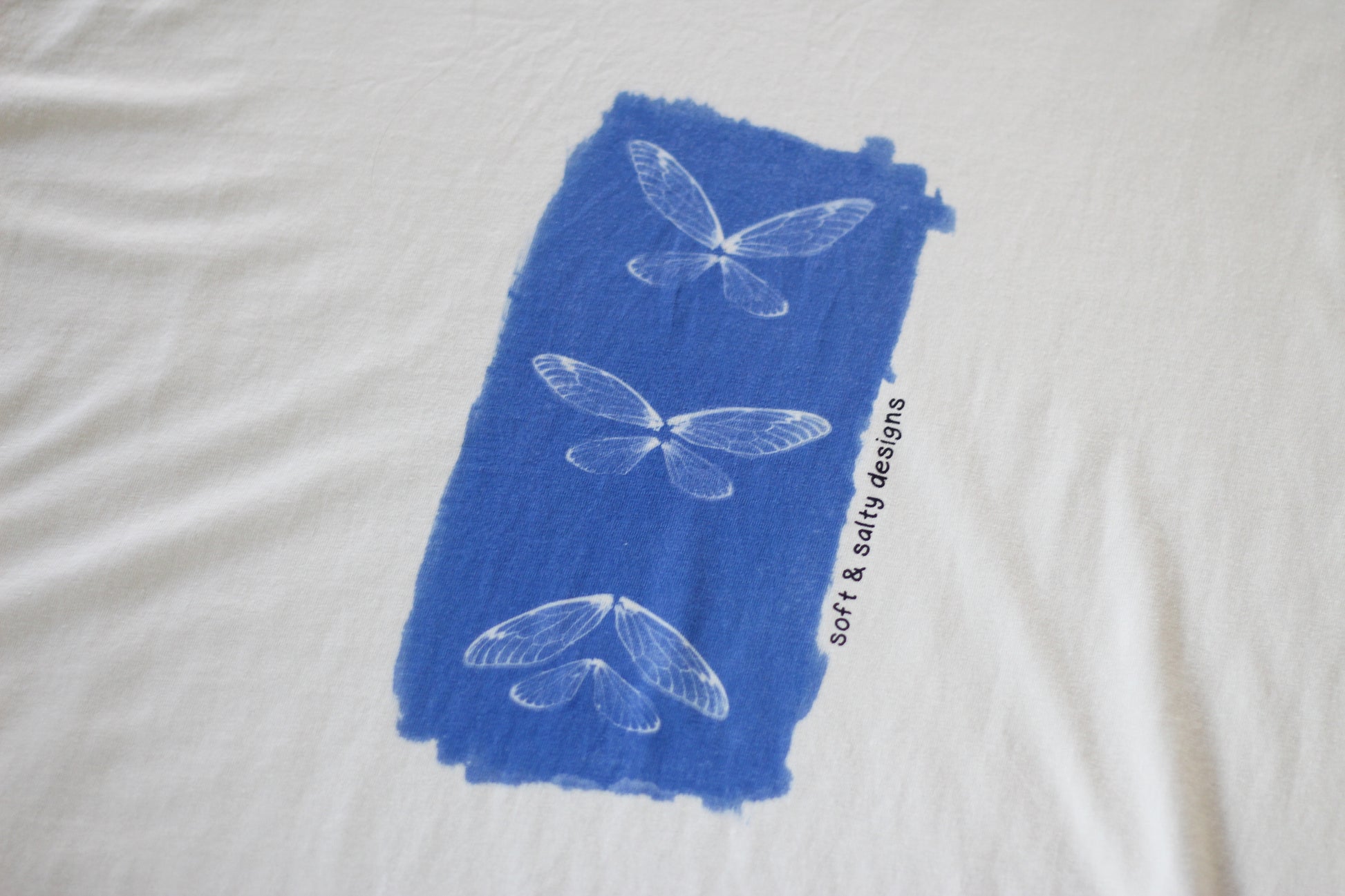 Close up of cicada wing hand-printed on an organic cotton t-shirt.