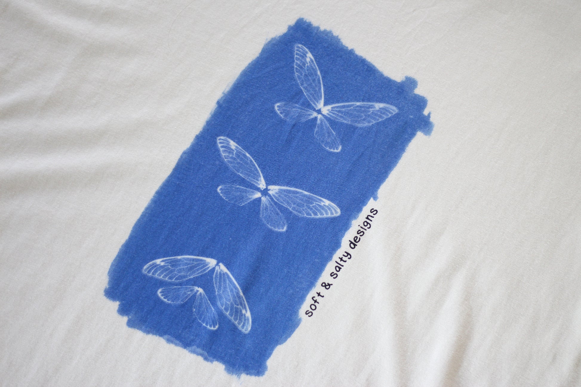 Close up of cicada wing hand-printed on an organic cotton t-shirt.