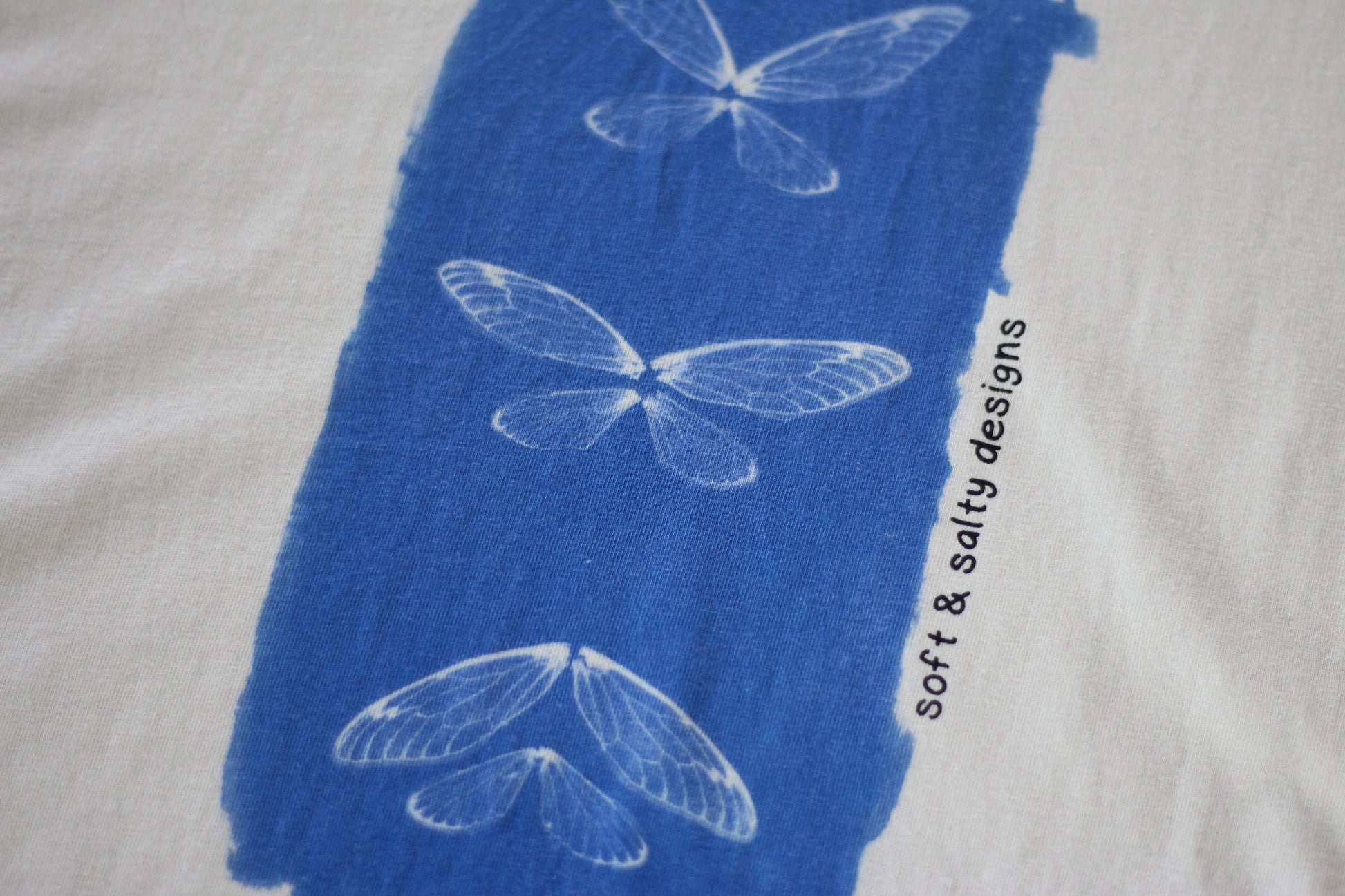 Close up of cicada wing print on organic cotton t-shirt.