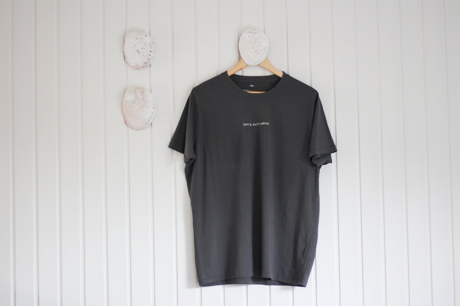 Grey t-shirt printed with 'soft and salty designs' logo
