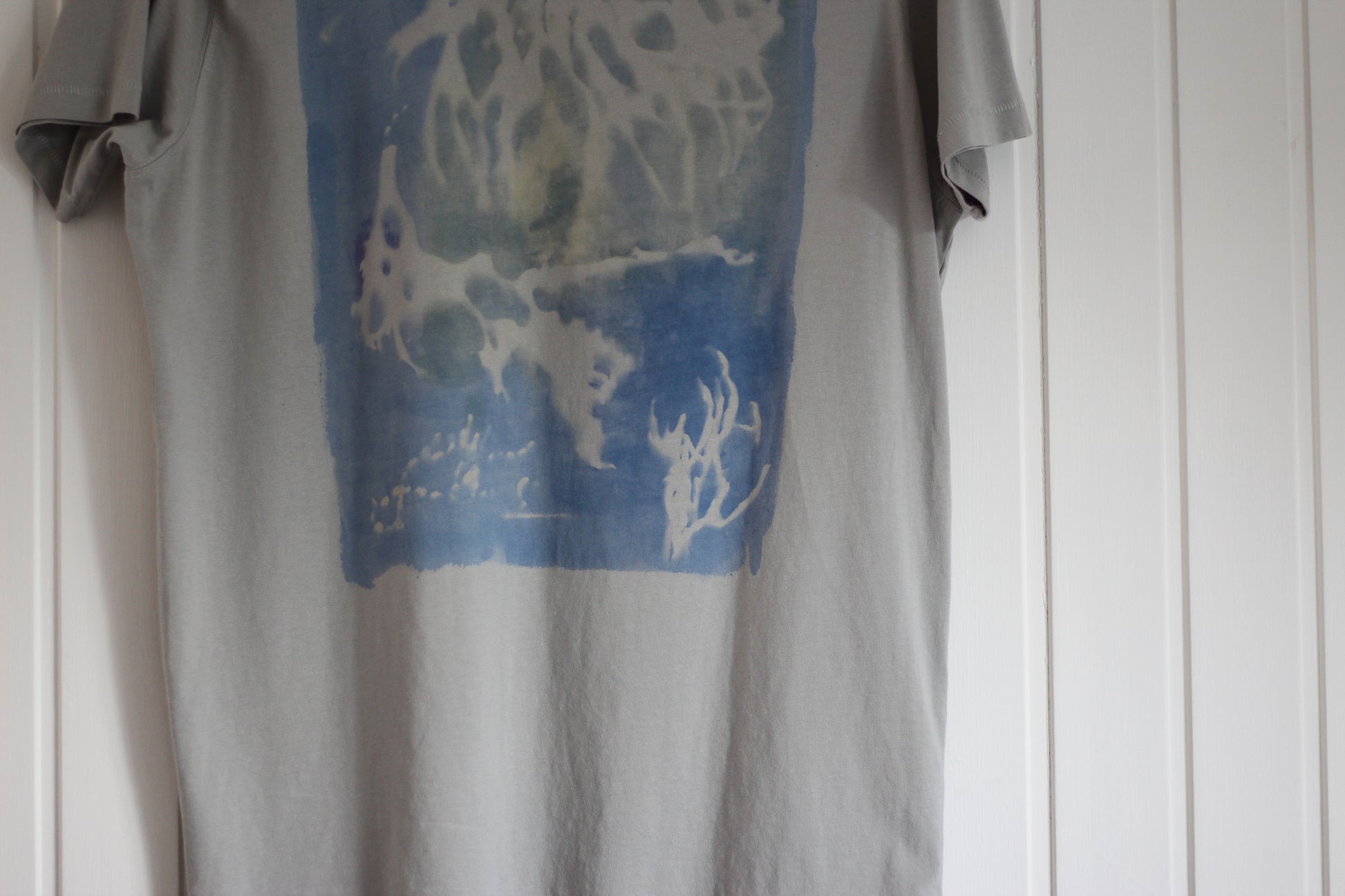 Graphic t-shirt with blue and green ocean-inspired sea sponge design, hand painted.