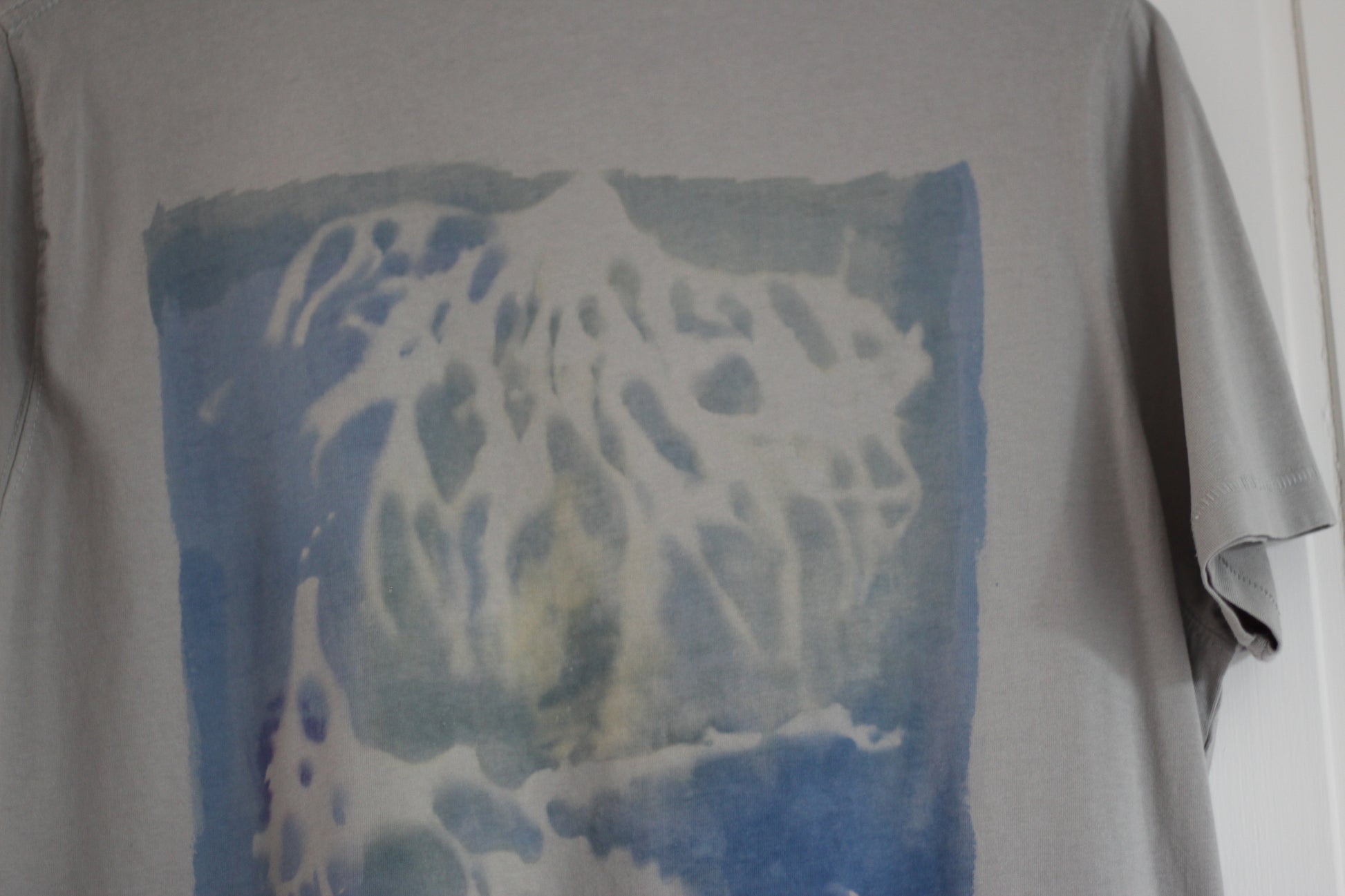 Graphic t-shirt with blue and green ocean-inspired sea sponge design, hand painted.