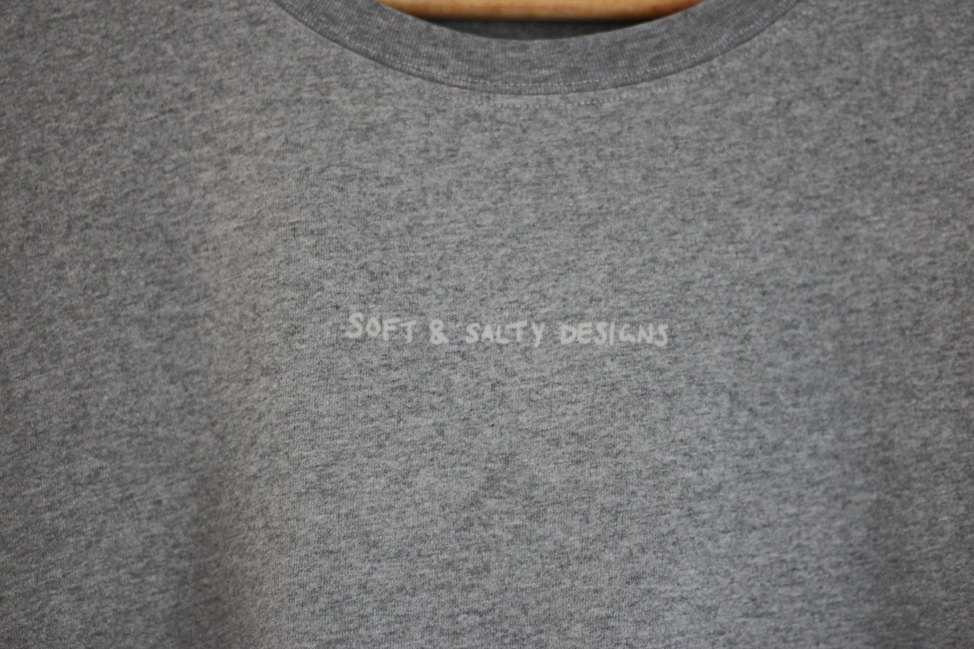 Gray marle GOTS organic t-shirt printed with 'soft and salty designs' logo.