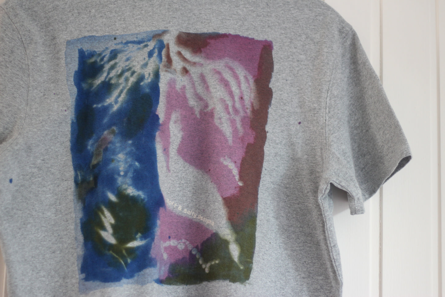 Gray t-shirt with a colorful abstract seaweed print design.