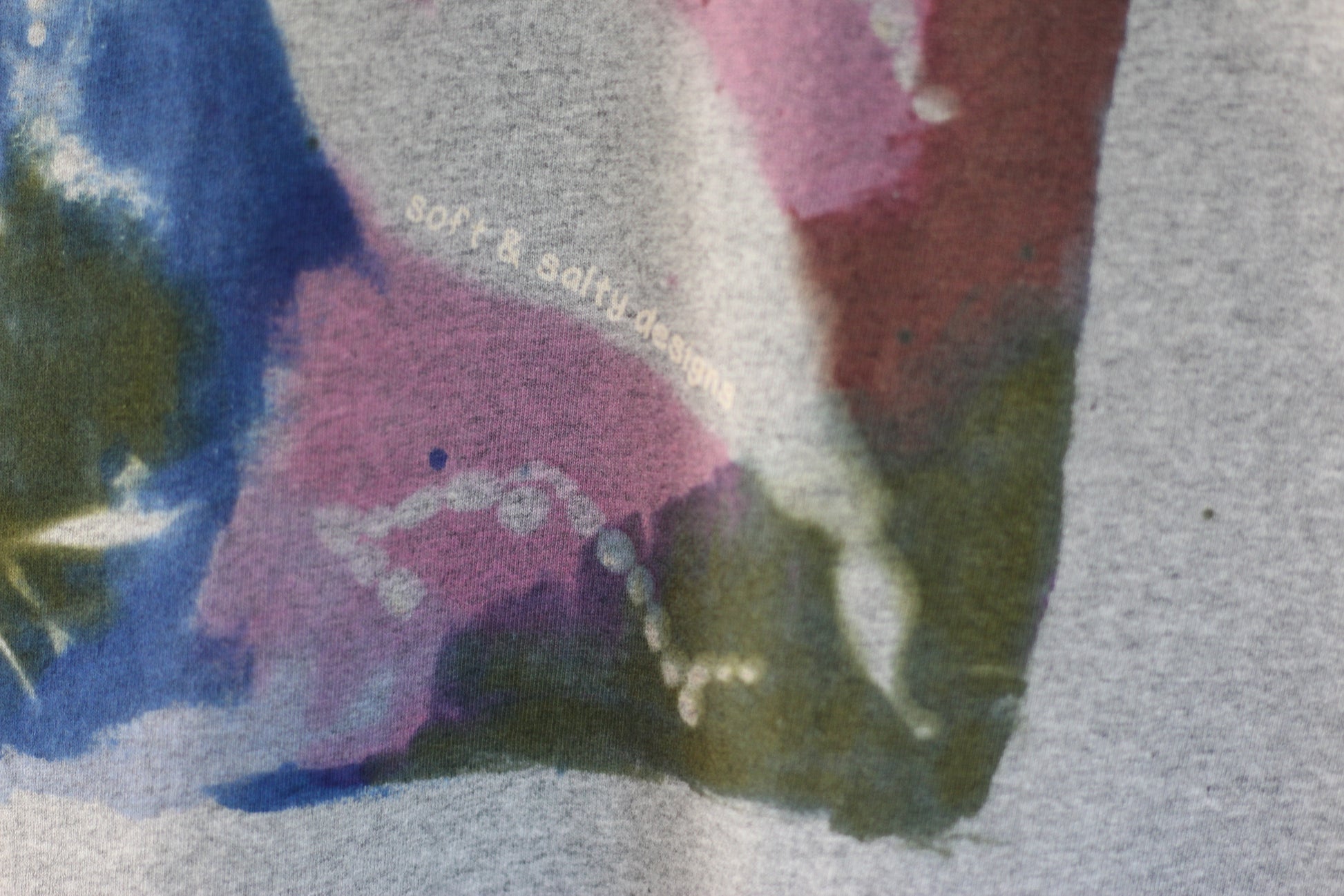 Gray t-shirt with colourful hand-printed seaweed design.