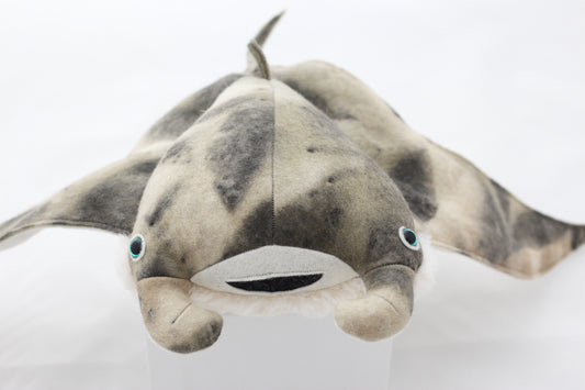 Plush toy manta ray with a white background