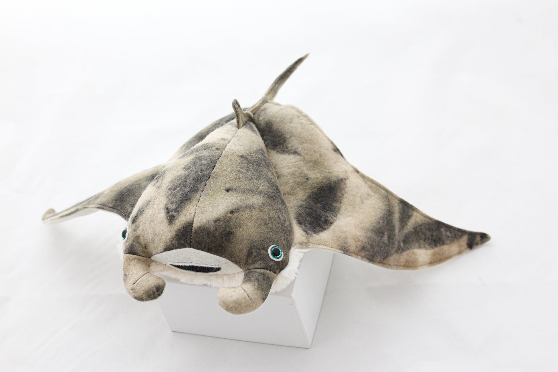 Plush toy manta ray with a white background