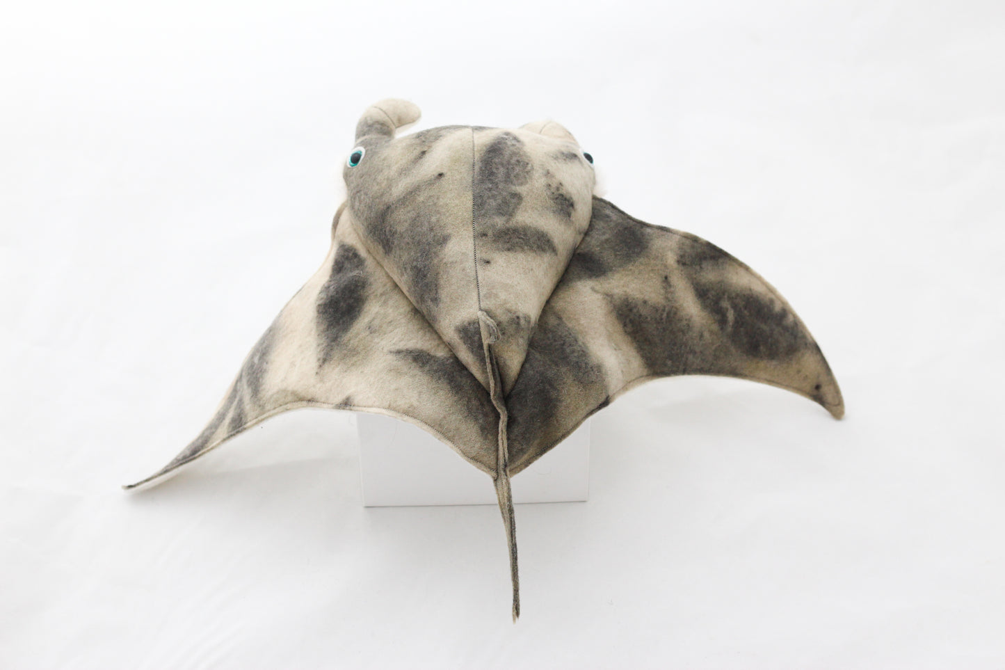Plush toy manta ray with a white background