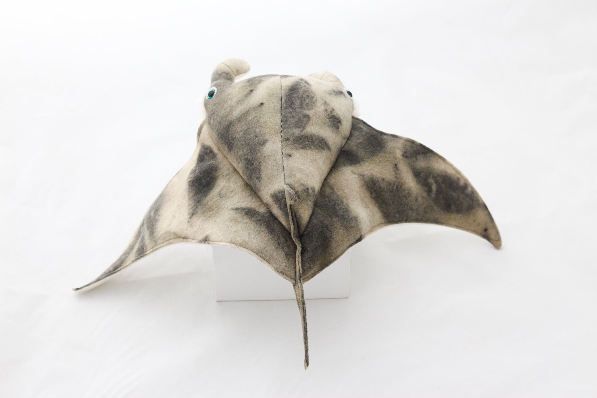 Plush toy manta ray with a white background