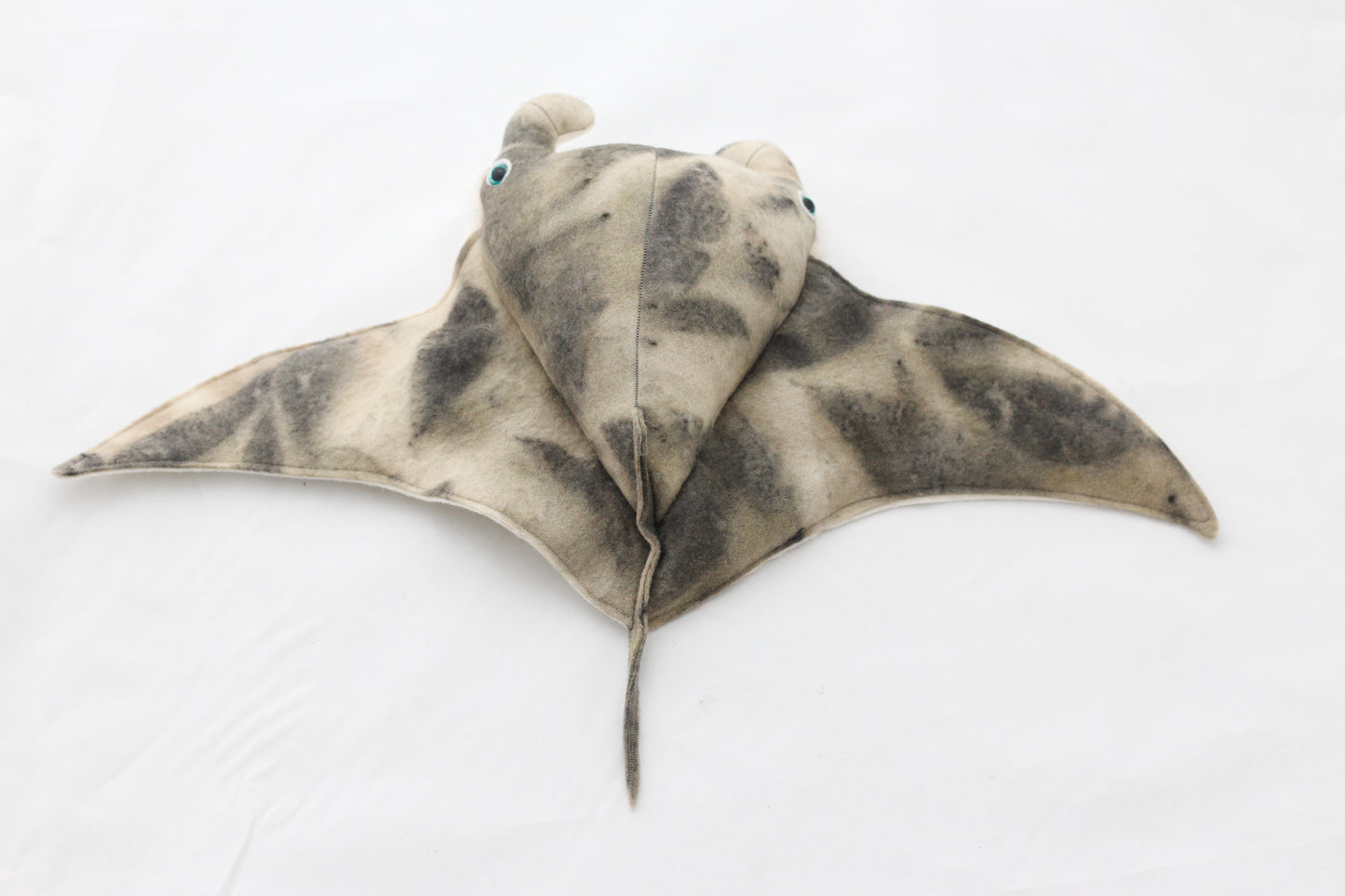 Plush toy manta ray with a white background