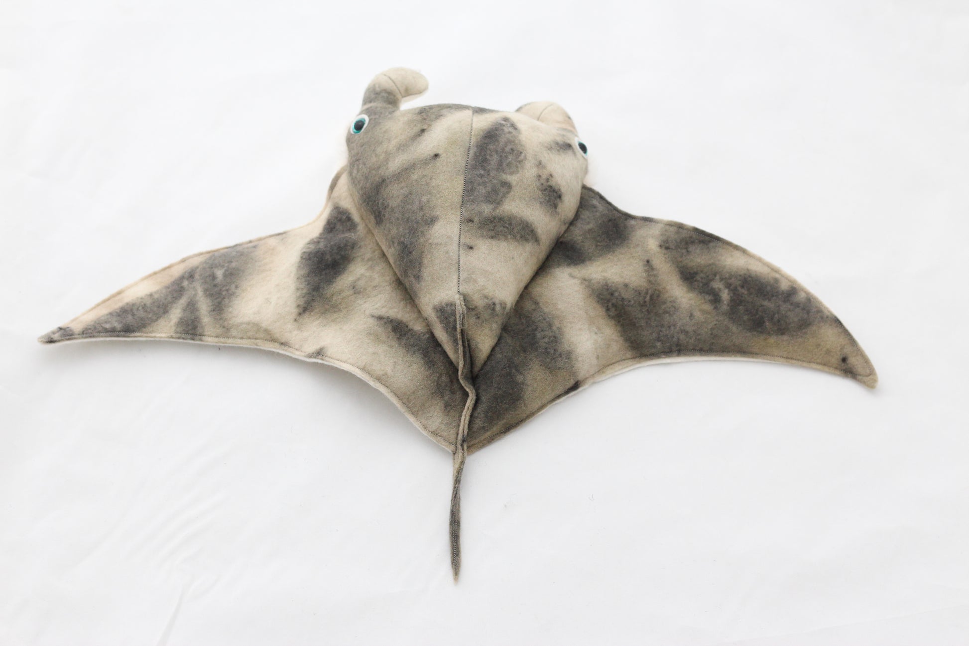 Plush toy manta ray with a white background