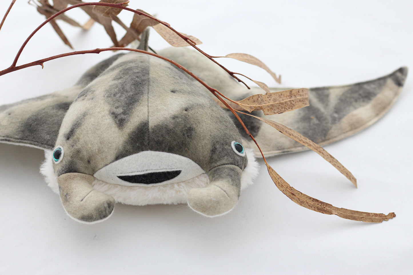 Plush toy manta ray with a white background