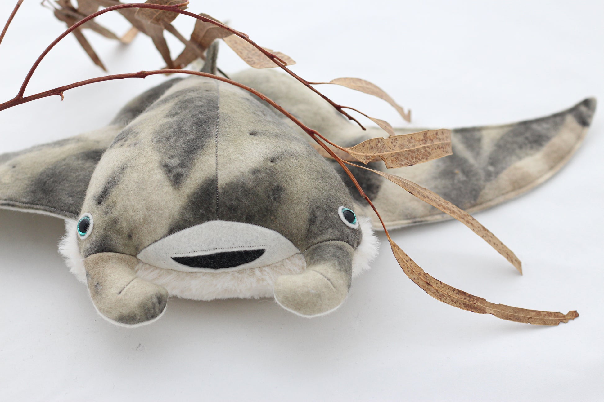 Plush toy manta ray with a white background
