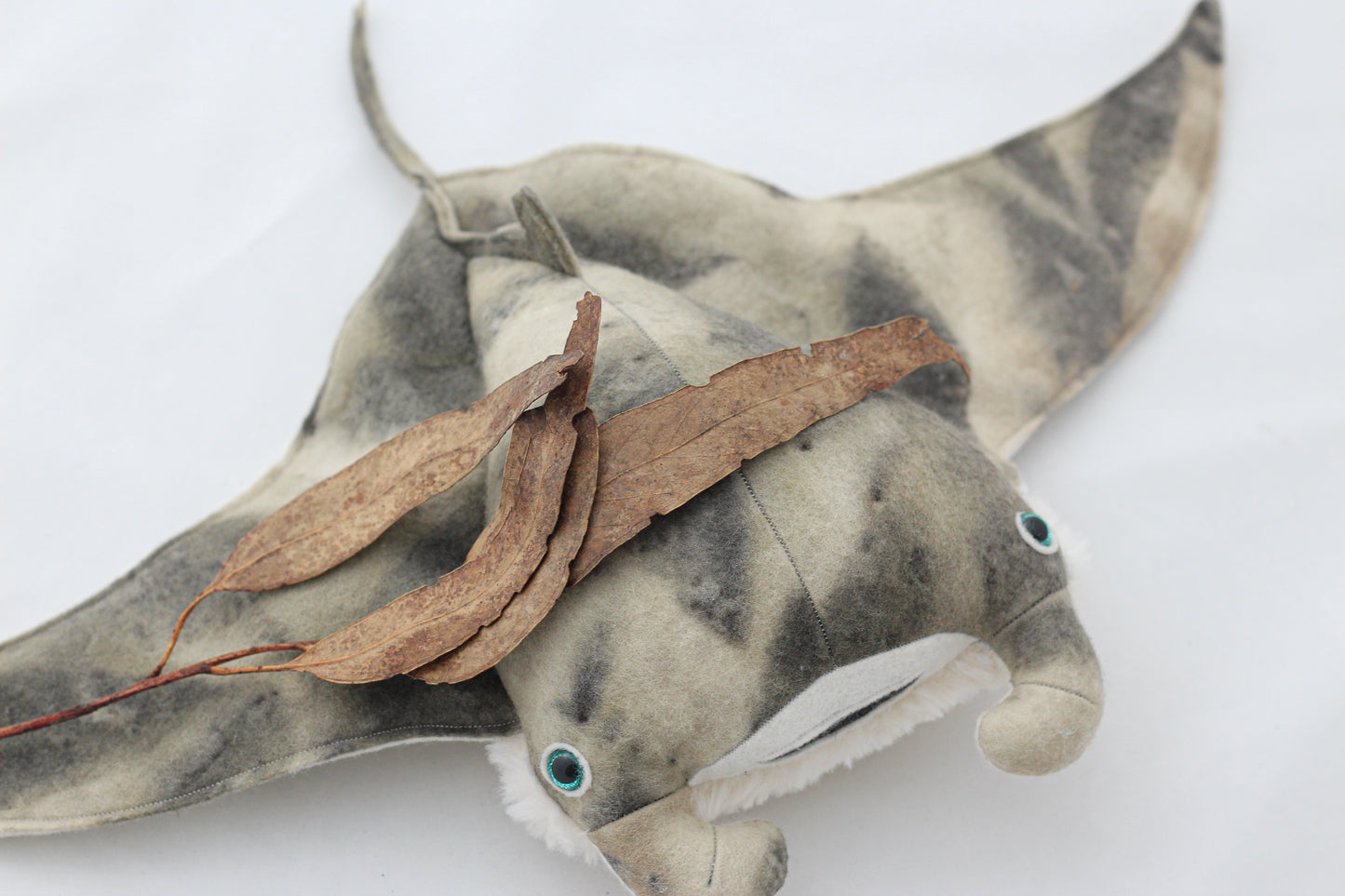 Plush toy manta ray with a white background