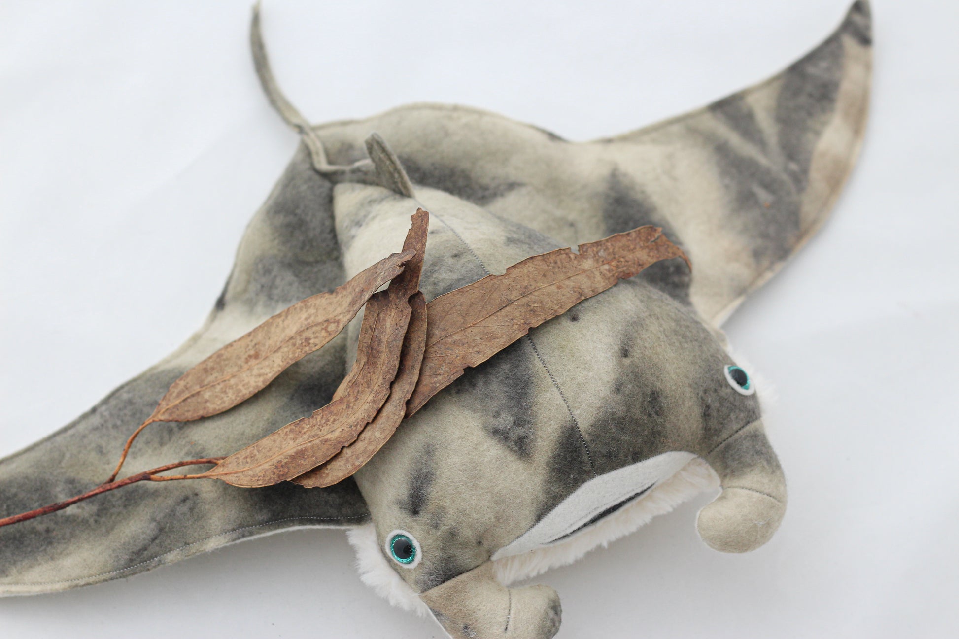 Plush toy manta ray with a white background