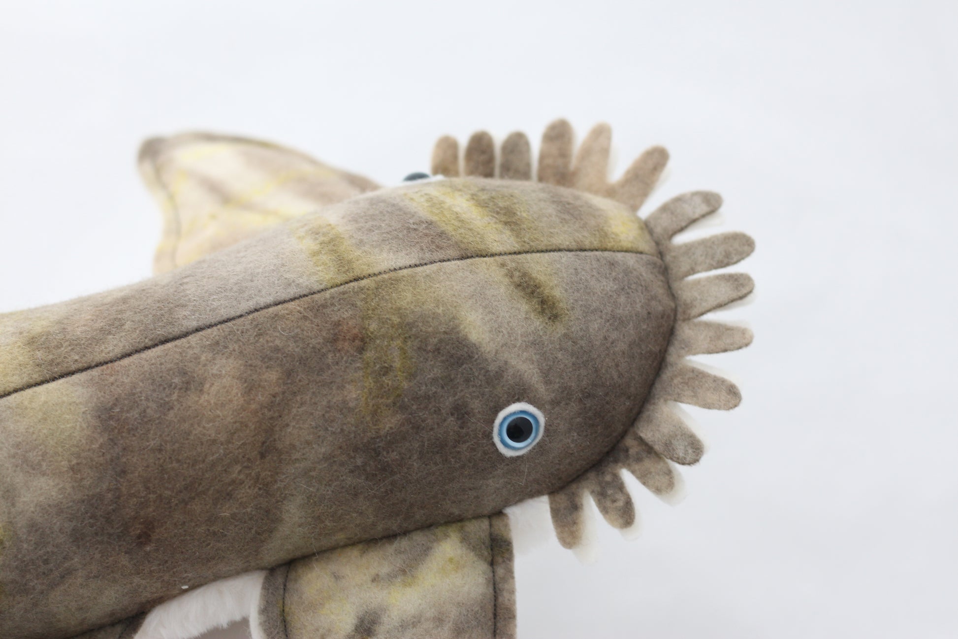 Plush wobbegong shark toy with brown and beige pattern on a white background