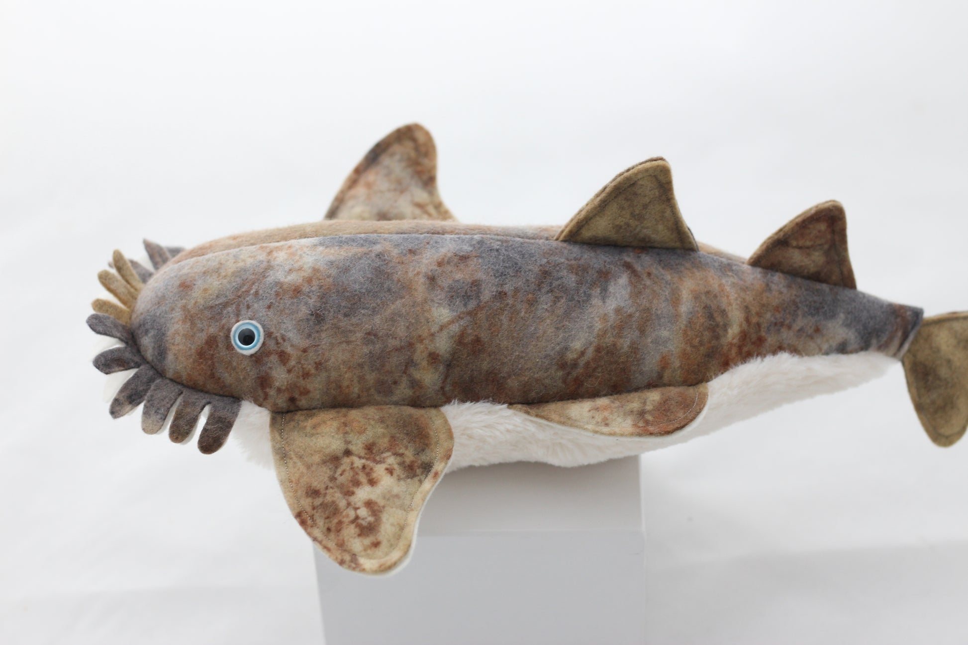 Plush wobbegong toy shark with brown and gray pattern on a white background