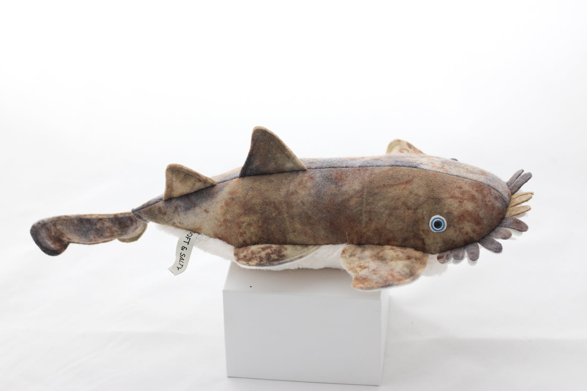 Plush toy wobbegong shark on a white background