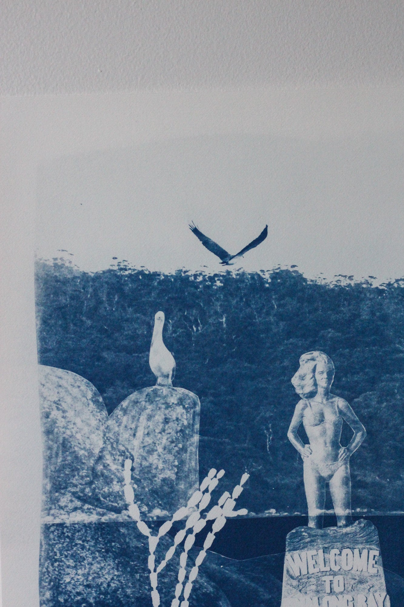 A blue and white cyanotype print artwork featuring a pelican, a sea eagle, and the Syrena of Binalong Bay statue overlooking Humbug point.